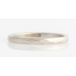 A shaped wedding band, stamped Platinum.