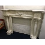 A white Adams style fluted column fire surround.