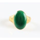 A green enamel ring, the oval head featuring green enamel and stepped shoulders, stamped 22 with