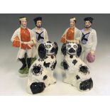 Four Staffordshire flatback figurines, to include a pair of black and white digs, with two sets of