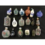 A selection of eighteen various snuff bottles, some glass with painted interiors, some blue and