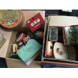 Two boxes of various advertising tins and lunchboxes.