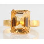 A single stone citrine ring, set with an emerald cut citrine, measuring approx. 11x9mm, stamped with