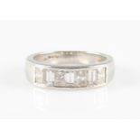 A platinum diamond half eternity ring, channel set with seven alternating emerald and princess cut