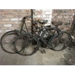 Three vintage bicycles, one Hercules black painted, one green painted, one with wicker basket.