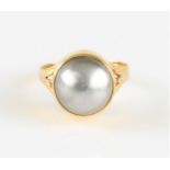 A grey mabe pearl dress ring, indistinctly stamped, ring size P.