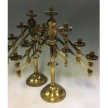 A pair of brass altar candlestick holders, with two adjustable branches holding seven lights,