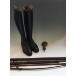 A pair of riding boots, riding crop, brass powder flask and shotgun ram rods.