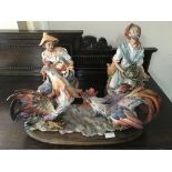 Three Capodimonte figurine groups, two hens, fish seller and fig seller.