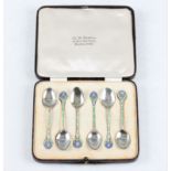 A boxed set of six silver and enamel coffee spoons, featuring green, blue and white enamel with