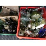 Three boxes of blue, green and clear glass bottles, some advertising eg Horlicks.