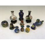 Fourteen miniature enamelled oriental design ornaments, to include eight vases, five with stands,