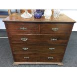 A mahogany bookcase base with three long and two short drawers.