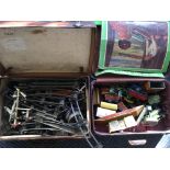 Two suitcases containing Chad Valley clockwork train set, including engines, carriages, stations,