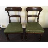 Six Holland & Sons mahogany Victorian dining chairs with green leather-padded seats.