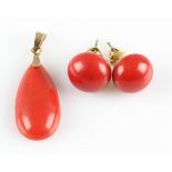 A part-suite of coral jewellery, comprising a pear cut coral cabochon pendant and a pair of button