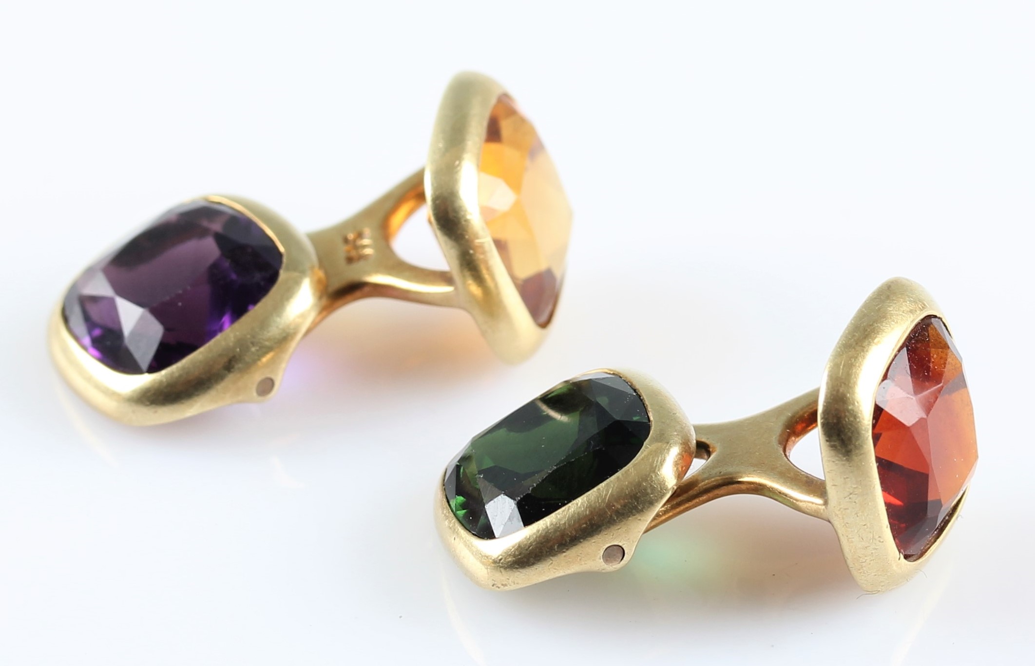 A pair of gemstone set cufflinks, set with cushion cut pieces of amethyst, citrine, tourmaline and a