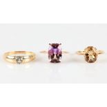 Three hallmarked 9ct yellow gold rings, one set with an amethyst, another set with a citrine and
