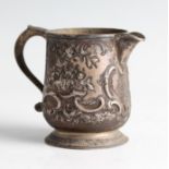 WITHDRAWN. A George III silver jug, featuring repousse floral and scroll design to body and raised