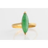 A green jadeite jade ring, set with a marquise jadeite cabochon, yellow metal stamped with Chinese