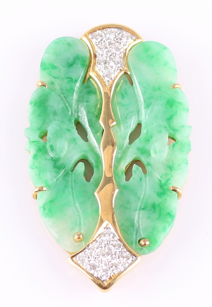 A carved jade and diamond plaque pendant, featuring a carved piece of green jade mounted in yellow