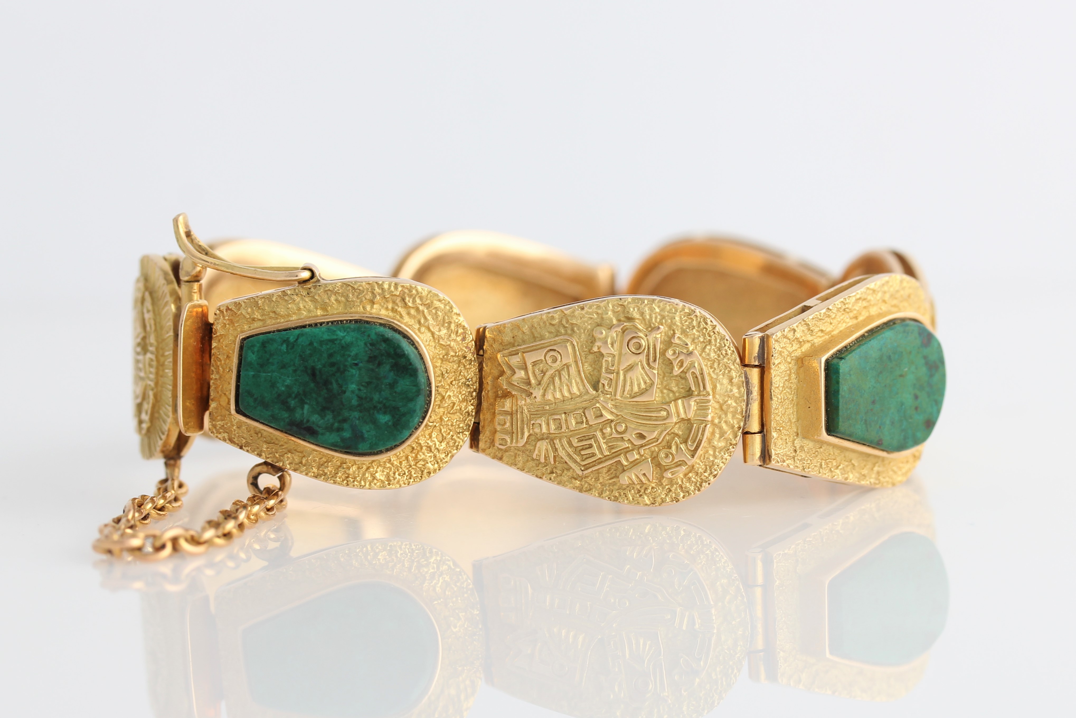 A Peruvian green stone bracelet, four links set with green hardstone panels, separated by links