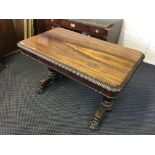 A rosewood two drawer side table sitting on two carved legs with tulip design and scrolled claw on