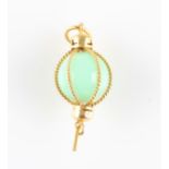 A green jade sphere pendant, set with a jade sphere encased in rope twist design, unmarked yellow