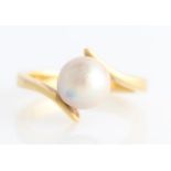 A pearl ring, set with a single pinkish pearl in cross over design band, pearl diameter approx. 8.
