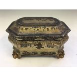 A tea caddie with gold and black painted oriental design to exterior, depicting ceremonial scene, on