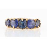 A Victorian 18ct yellow gold five stone blue paste ring, set with five graduated cushion cut blue