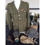 A World War Two Warwickshire regiment jacket with ribbons together with an air raid metal helmet,