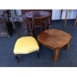 A yellow upholstered card backed nursing chair together with a mahogany round topped occasional