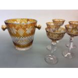 A amber coloured glass Champagne bucket and five matching Champagne bowls, one glass chipped to rim.