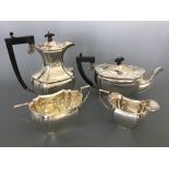 A silver four piece tea set consisting of a tea pot with ebony handle and finial, similar hot