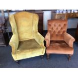 A 19 century upholstered wing back fireside chair with turned legs together with a button backed