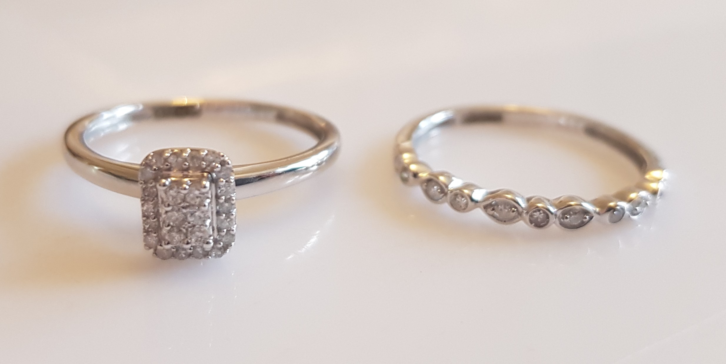 *A 9ct white gold and diamond engagement ring and half eternity ring set, both set with diamond