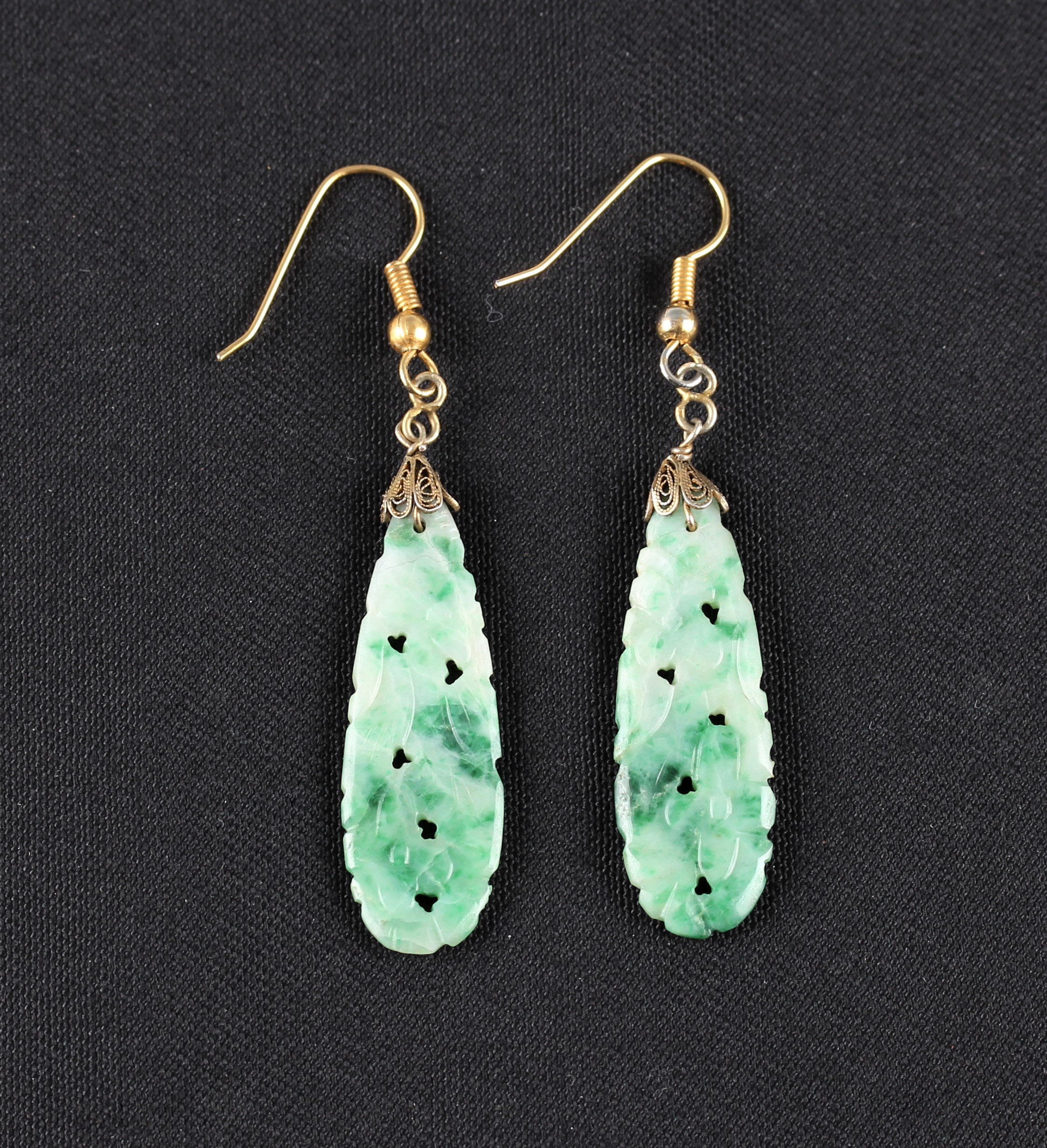 A pair of green jadeite jade earrings, each set with an oval jadeite cabochon, measuring approx. - Image 2 of 2