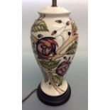 *A modern Moorcroft lamp base, cream background with floral pattern. 36cm high. IMPORTANT: Online