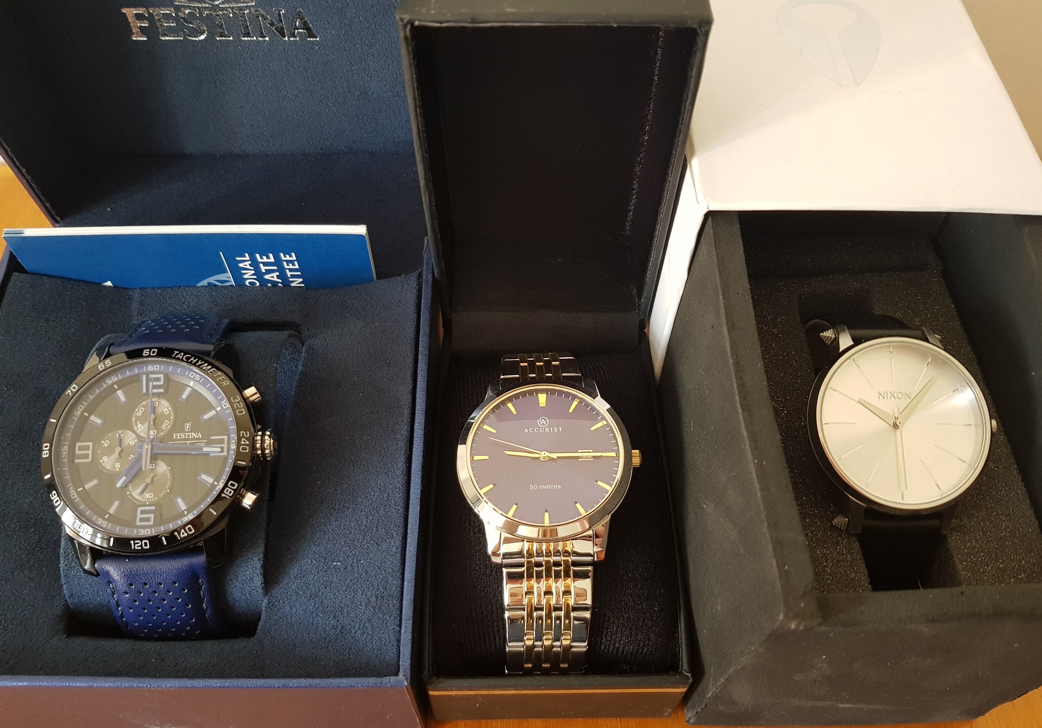 *Three various boxed wrist watches, to include the names Nixon, Festina and Accurist. IMPORTANT: