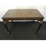 A walnut coffee table, on scroll and acanthus leaf design legs and lions feet, with glass cover to