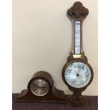 An oak mercury filled banjo style wall barometer together with a Greenwood and sons mantel clock.