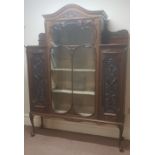 A mahogany display cabinet with single large glazed door, velvet interior with two side cupboards