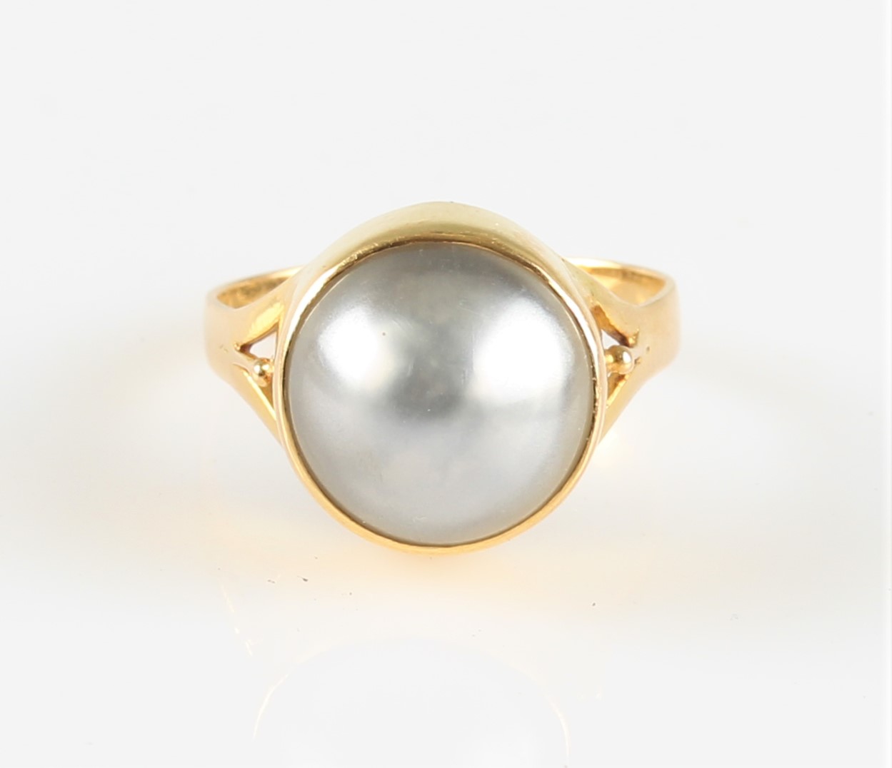 A grey mabe pearl dress ring, indistinctly stamped, ring size P. IMPORTANT: Online viewing and