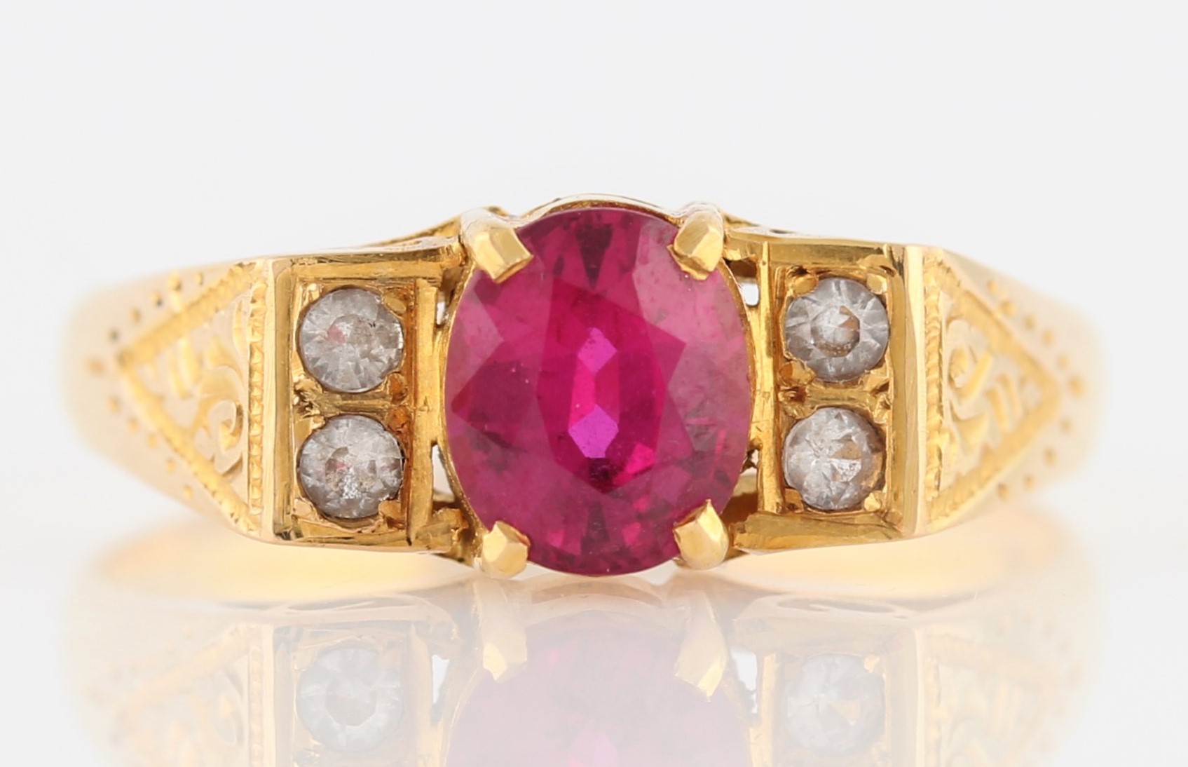 A ruby and colourless paste ring, set with an oval cut ruby, possibly synthetic, measuring approx.