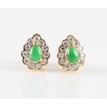 A pair of green jade and diamond cluster stud earrings, each set with a pear cut jade cabochon,