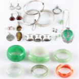 A collection of six stone band rings, five being green hardstones and the other being banded