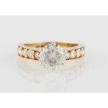 *A hallmarked 9ct yellow gold moissanite ring, set with a central round brilliant cut moissanite,