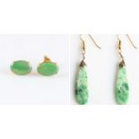 A pair of green jadeite jade earrings, each set with an oval jadeite cabochon, measuring approx.