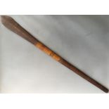 A Solomon Islands paddle club, with medial ridges to blade and part woven handle, length 118cm.